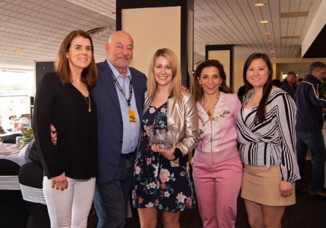The Thoroughbred Aftercare Alliance accepts the Award of Merit at the 2019 Alibi Breakfast during Preakness week.